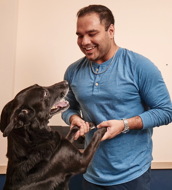 Dog mom with dog wagging his tail at Bond Vet